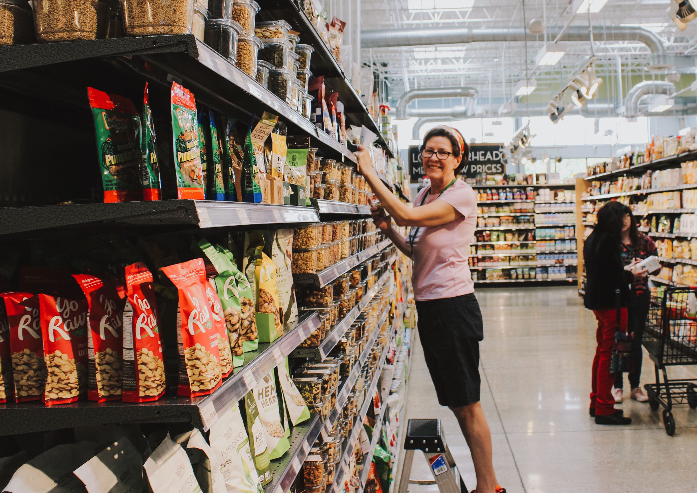 Smiling employee stocking shelves